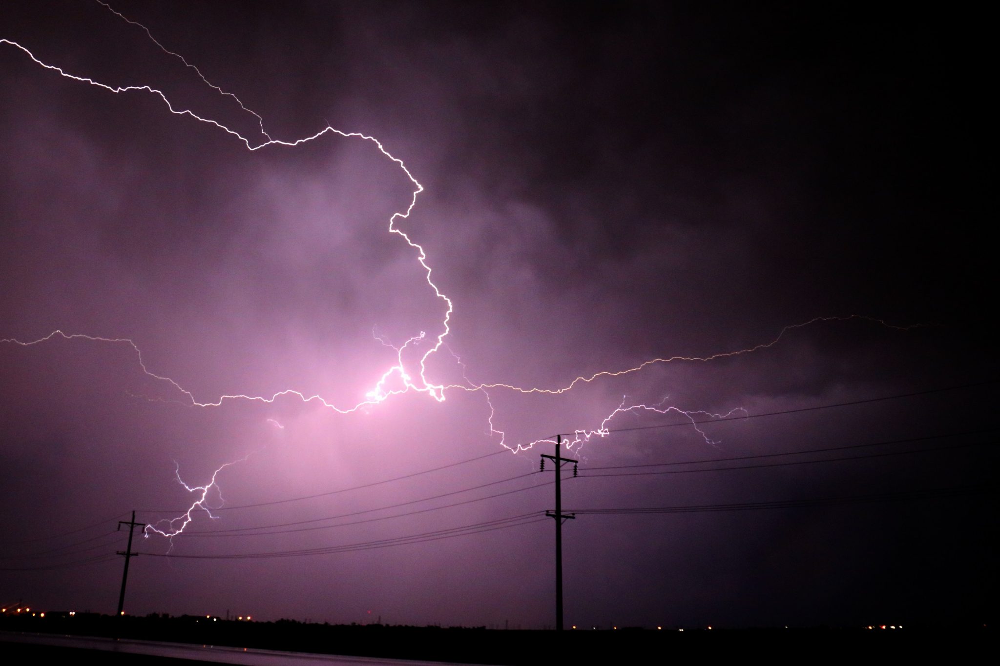Lightning Strikes and electricity pole in background